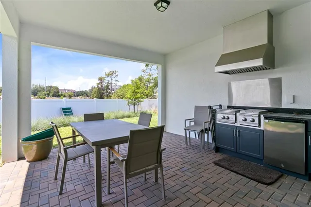 a view of a dining room with furniture a rug and wooden floor