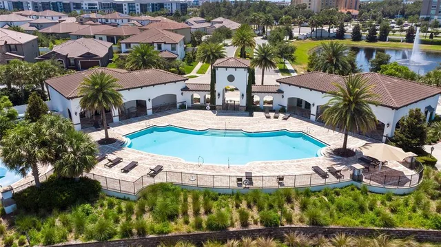 an aerial view of a house with garden space and lake view