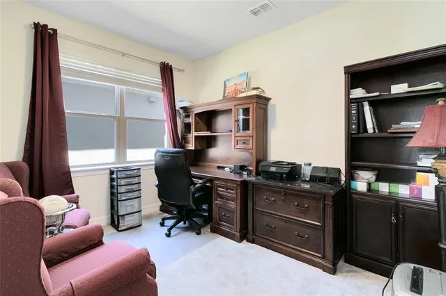 a livingroom with workspace and a window