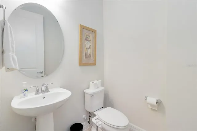a bathroom with a sink a mirror and a toilet