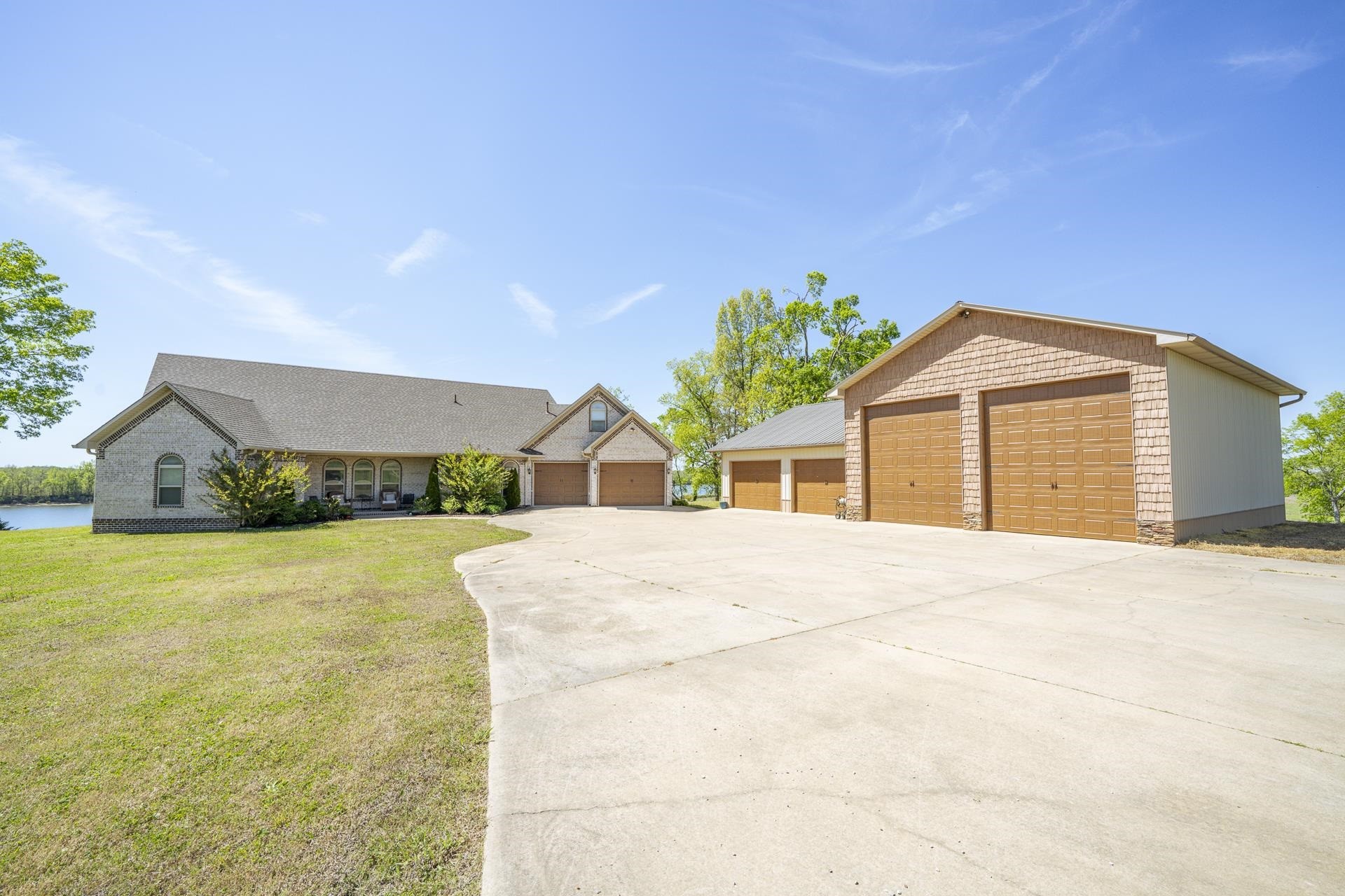875 Faith Lane Savannah, TN 38372 - Photo 1 of 40 a front view of a house with a garden and yard