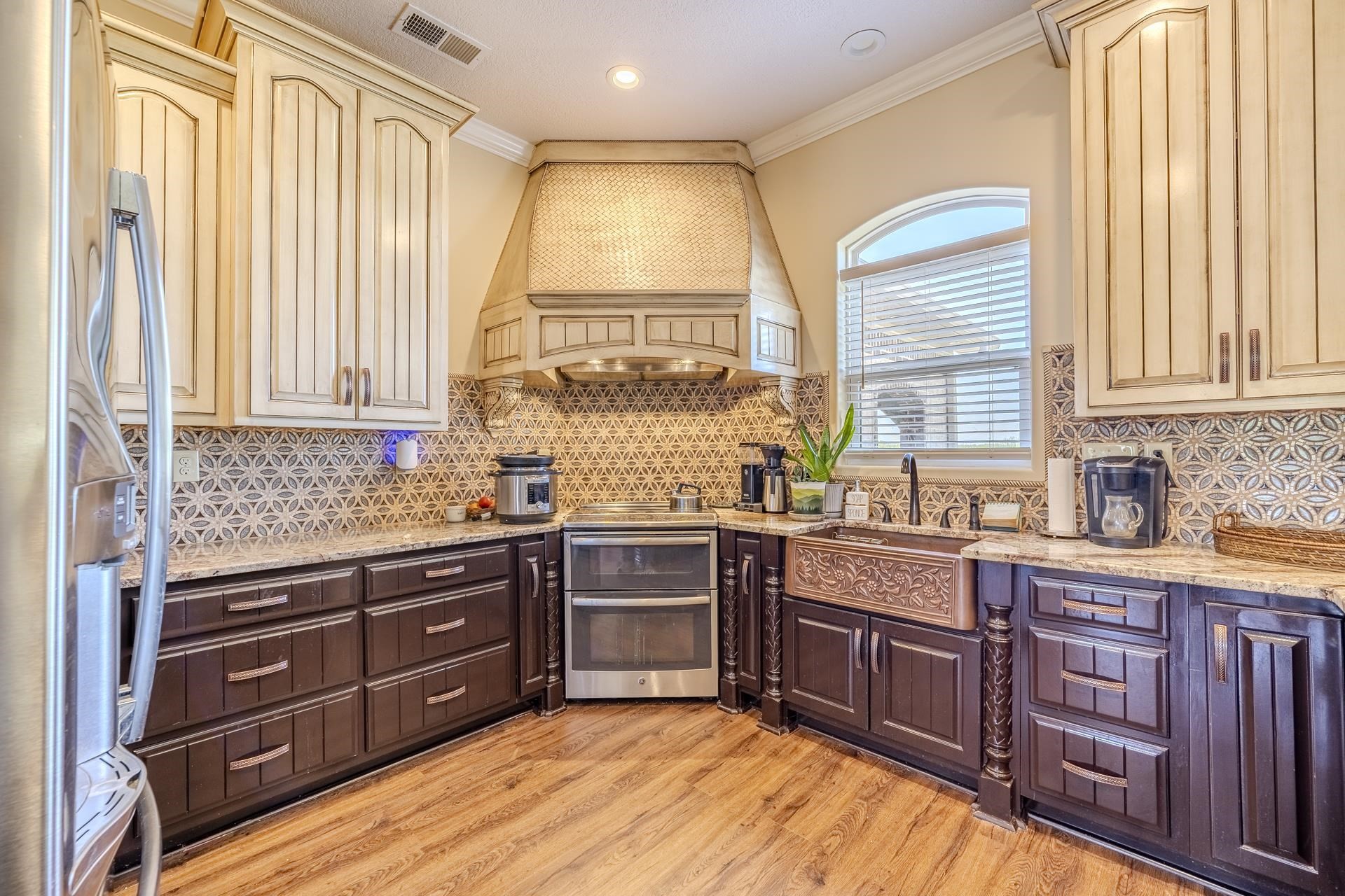 875 Faith Lane Savannah, TN 38372 - Photo 2 of 40 a kitchen with stainless steel appliances granite countertop wooden cabinets a sink and a window
