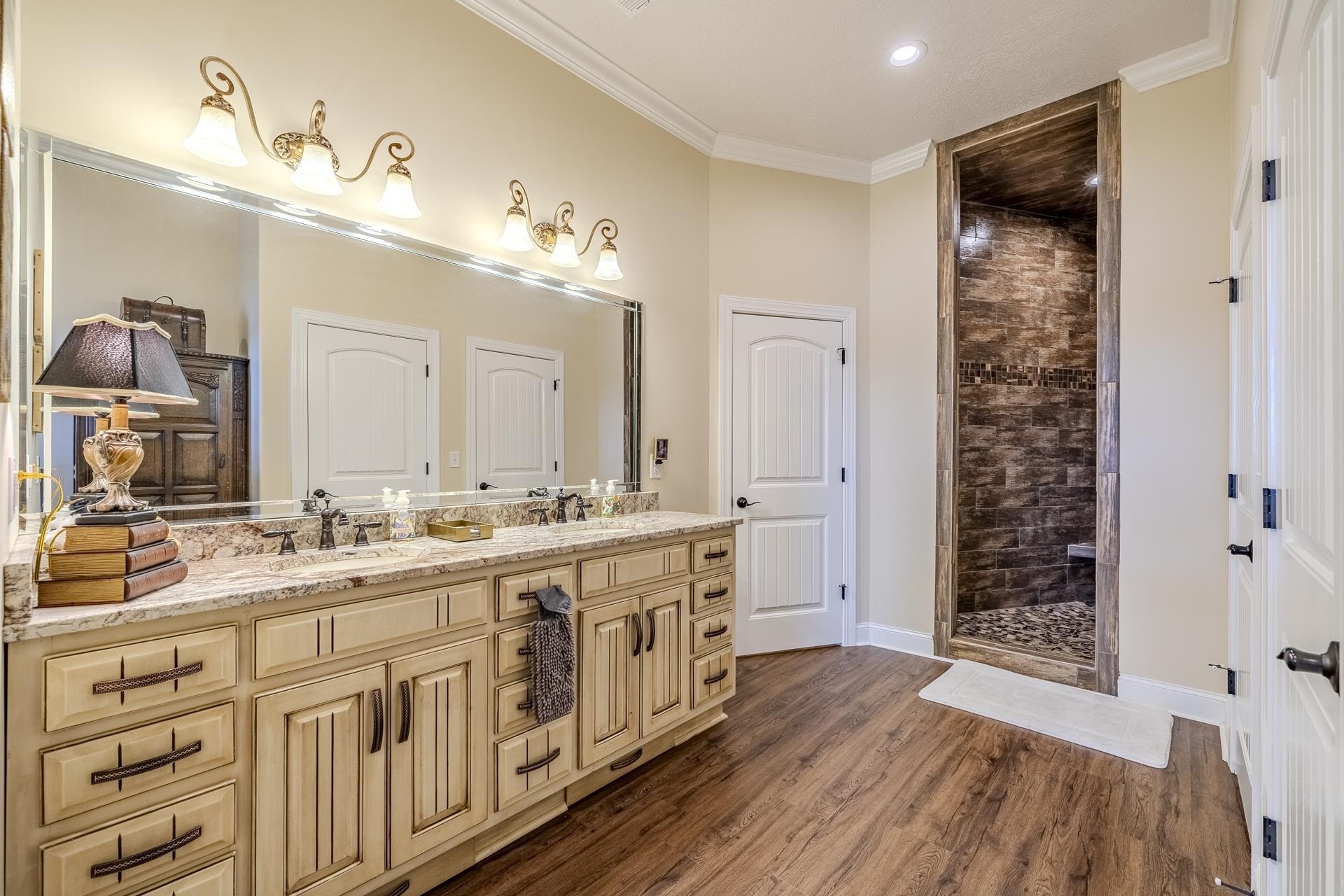875 Faith Lane Savannah, TN 38372 - Photo 21 of 40 a spacious bathroom with a double vanity sink a mirror a shower and a bathtub