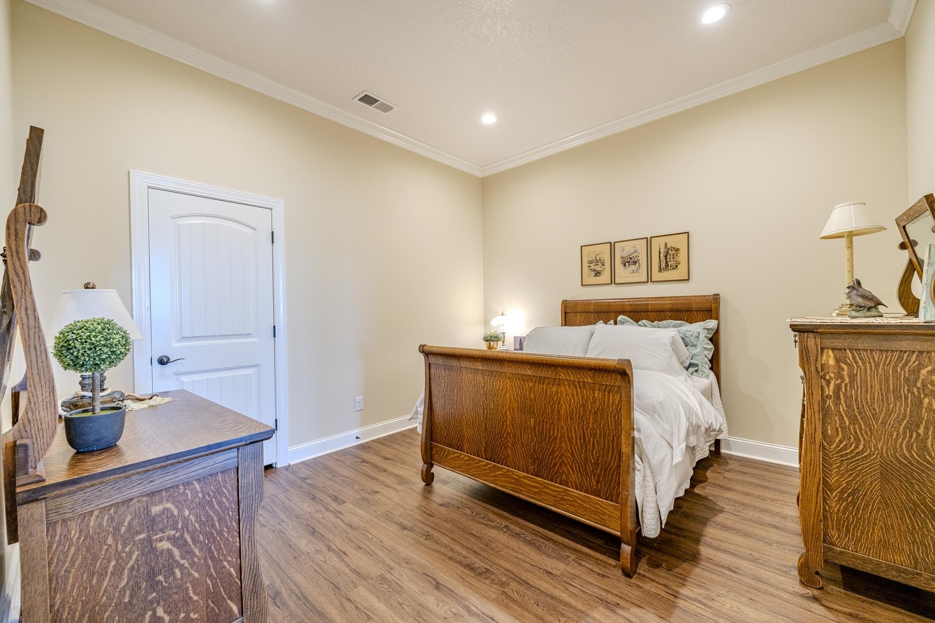 875 Faith Lane Savannah, TN 38372 - Photo 23 of 40 a bedroom with bed and a potted plant