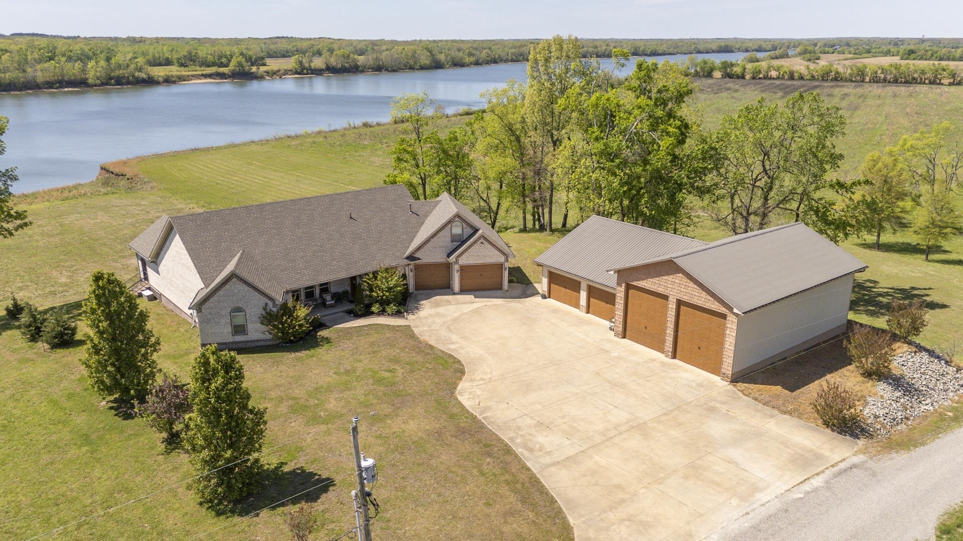 875 Faith Lane Savannah, TN 38372 - Photo 35 of 40 a view of a lake with a house in the background