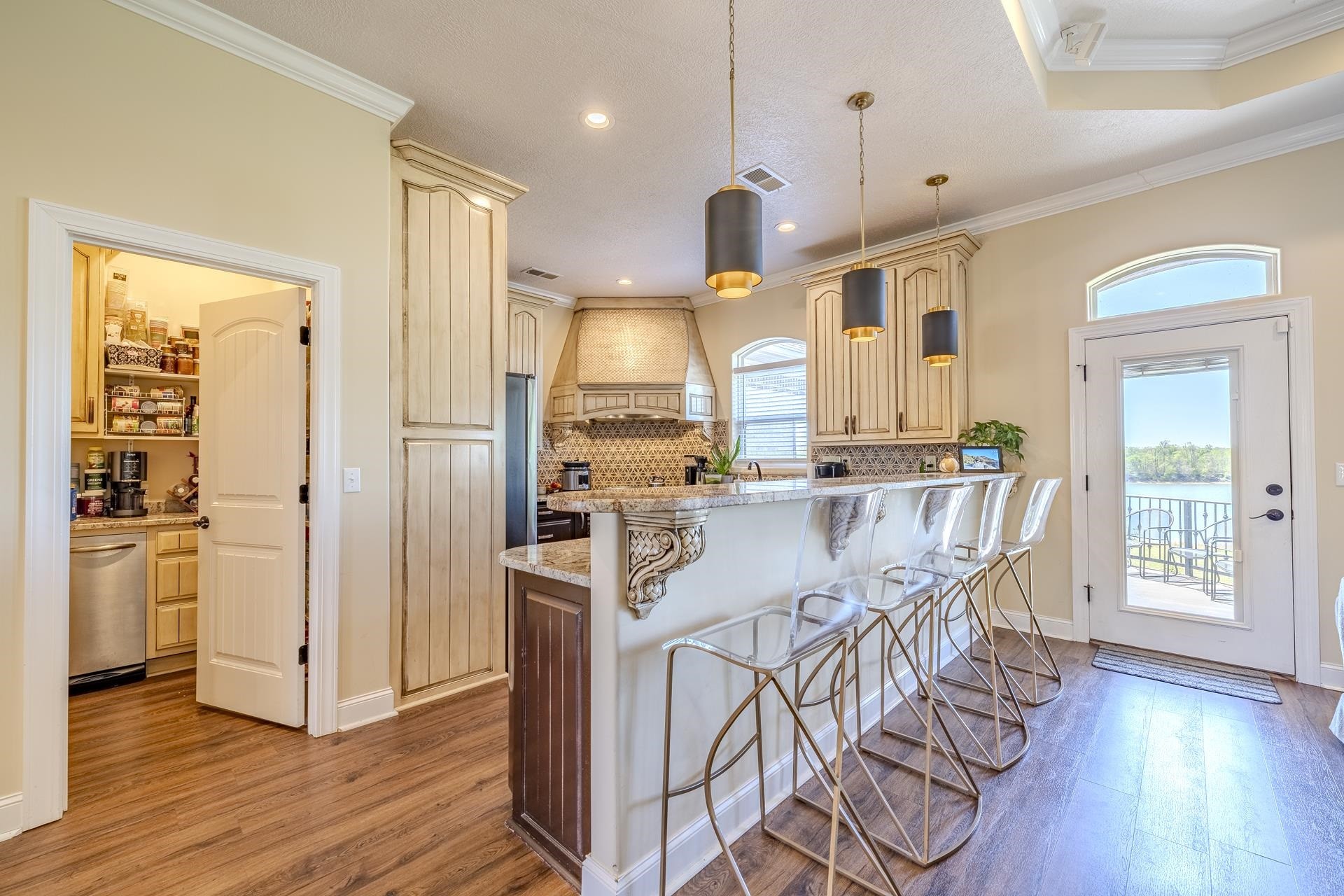875 Faith Lane Savannah, TN 38372 - Photo 5 of 40 a kitchen with stainless steel appliances granite countertop a refrigerator a stove and a wooden floors