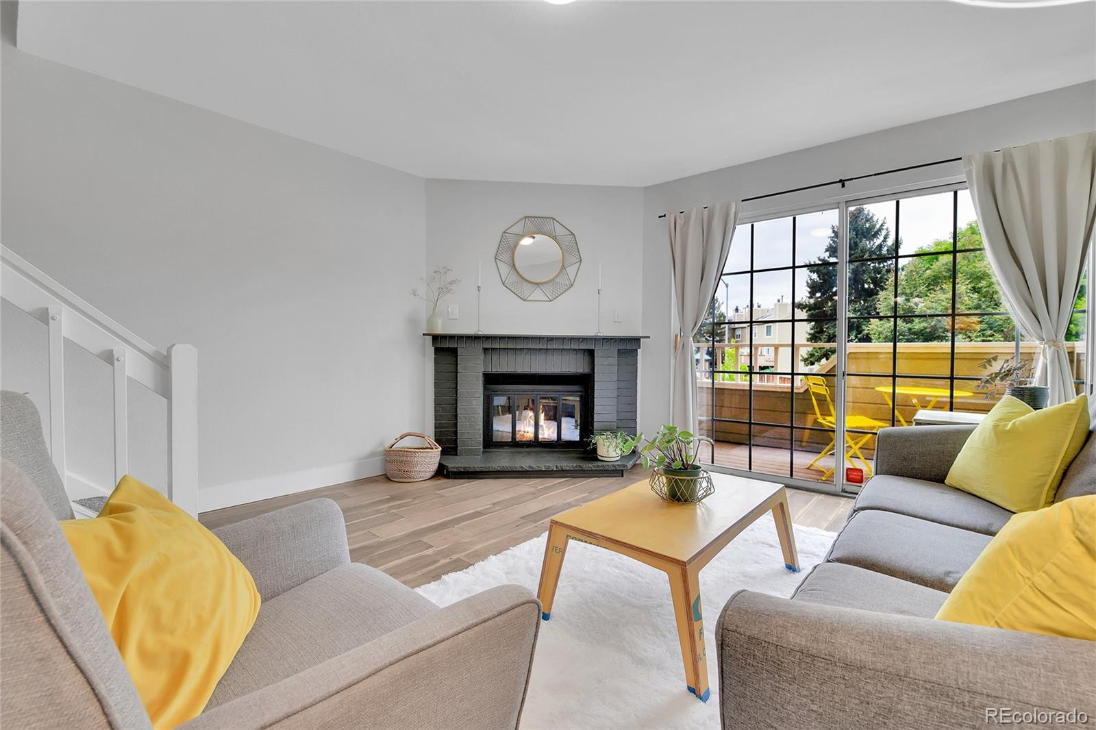 1818 South Quebec Way, Unit 46 Denver, CO 80231 - Photo 1 of 34 a living room with furniture and a fireplace