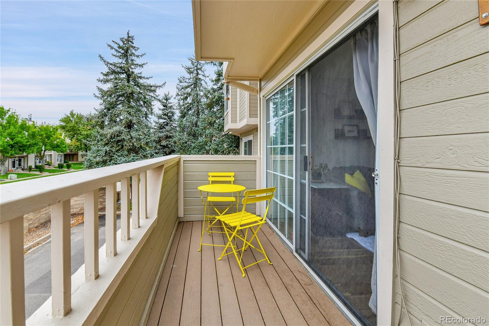 1818 South Quebec Way, Unit 46 Denver, CO 80231 - Photo 15 of 34 a view of balcony with wooden floor and outdoor seating