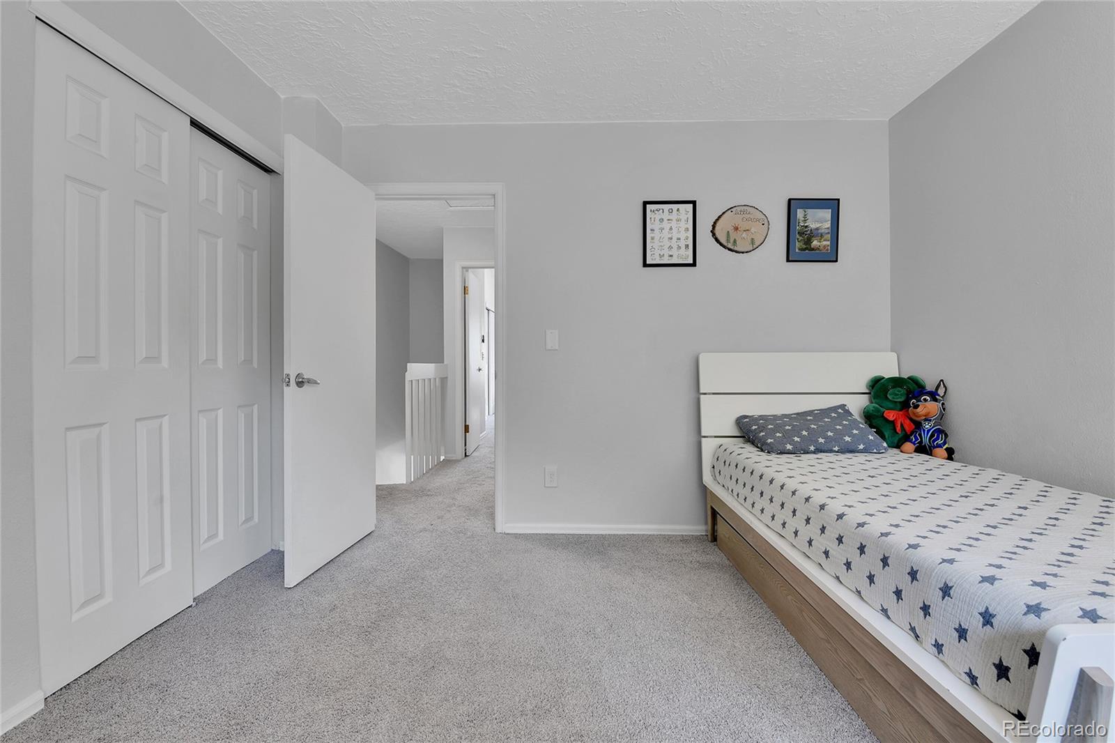 1818 South Quebec Way, Unit 46 Denver, CO 80231 - Photo 17 of 34 a bedroom with a bed and painted walls