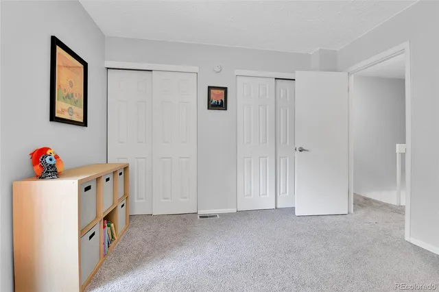 a view of an empty room with baby crib