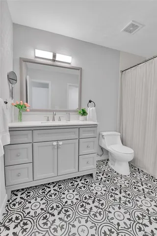 a bathroom with a sink toilet and a mirror