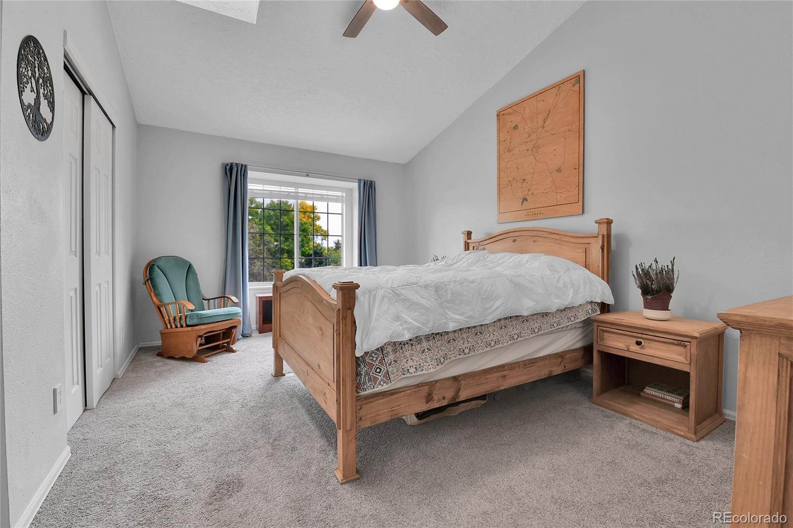 1818 South Quebec Way, Unit 46 Denver, CO 80231 - Photo 23 of 34 a bedroom with a bed and a chandelier