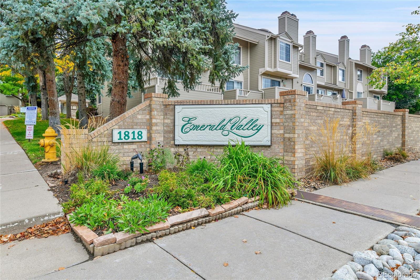 1818 South Quebec Way, Unit 46 Denver, CO 80231 - Photo 31 of 34 a sign on the side of a building