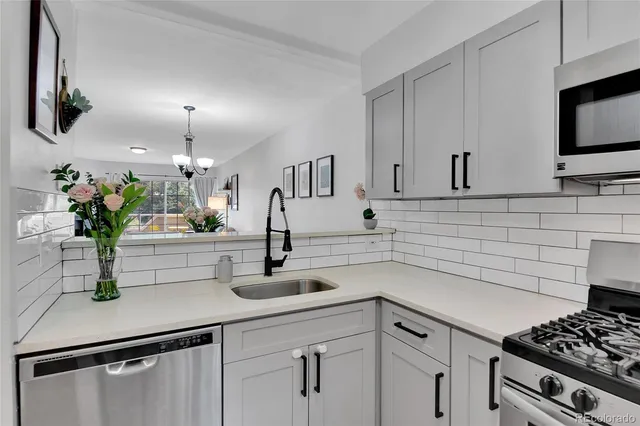 a kitchen with sink and white cabinets