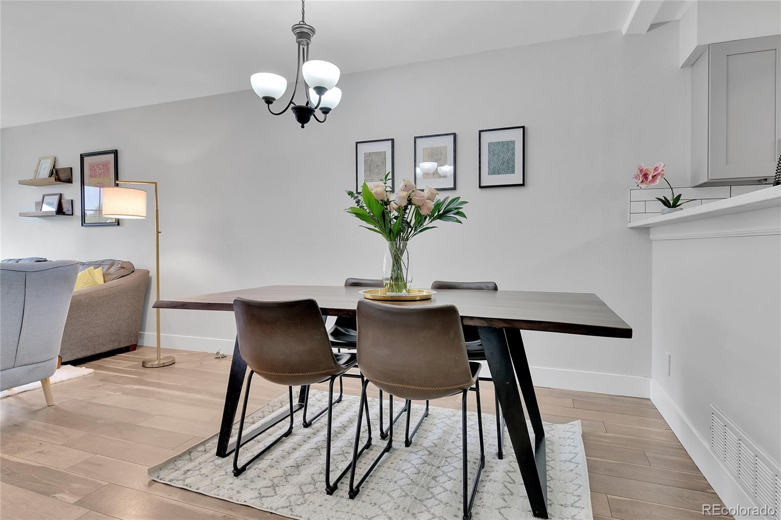 1818 South Quebec Way, Unit 46 Denver, CO 80231 - Photo 7 of 34 a view of a dining room with furniture and wooden floor