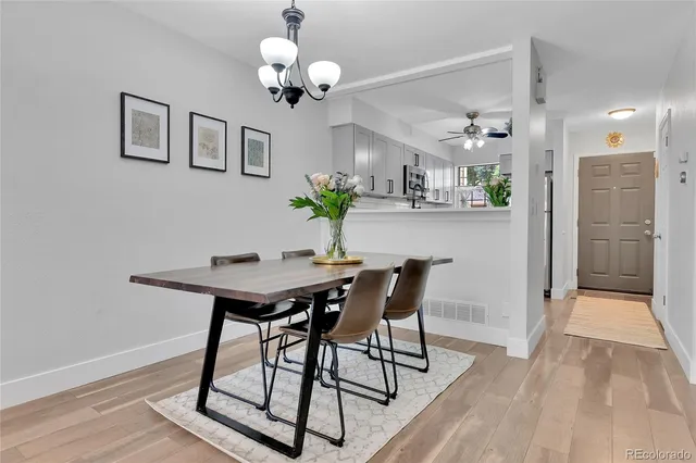 a view of a dining room with furniture and chandelier