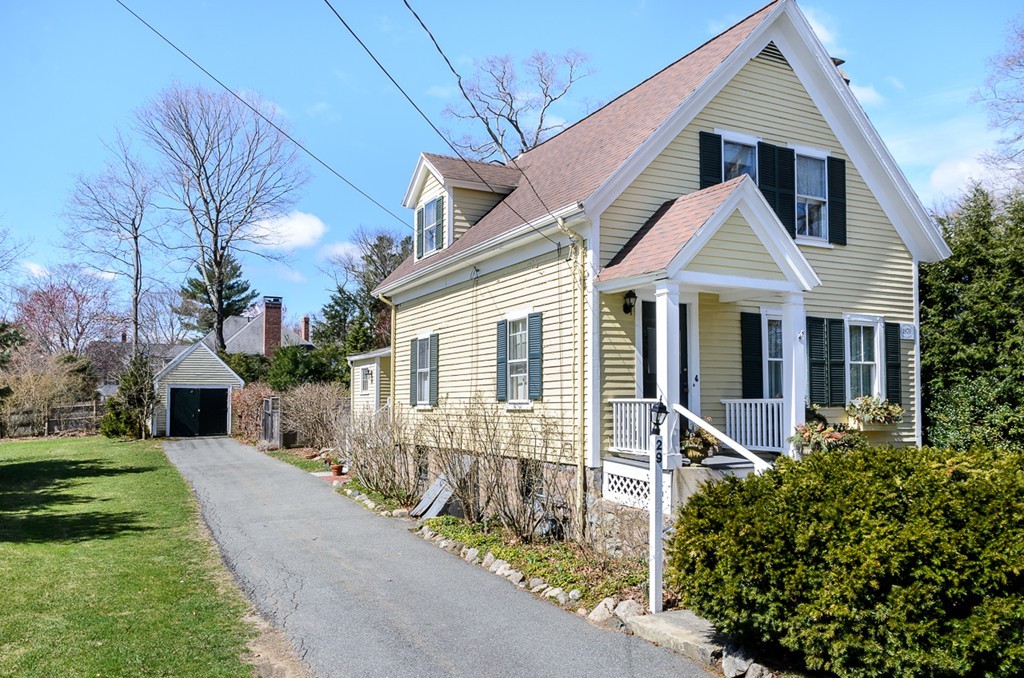 a front view of a house with yard and green space