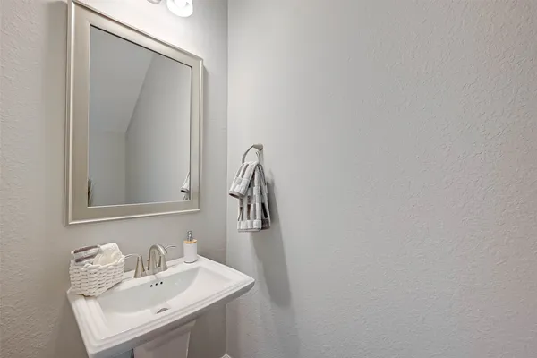 a bathroom with a sink and mirror