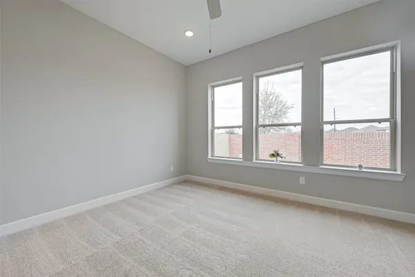 an empty room with windows and closet