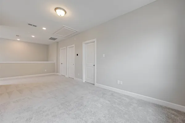 a view of an empty room with a window and closet area