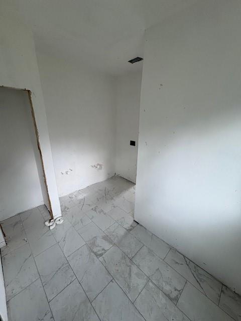2688 Columbia Drive Decatur, GA 30034 - Photo 16 of 19 an empty room with white walls and tiles