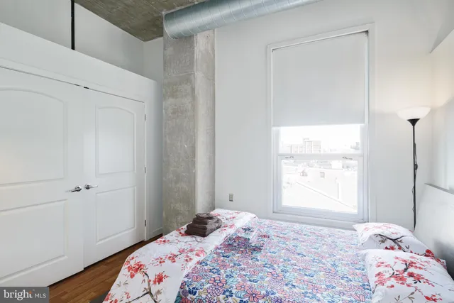 a bedroom with a bed and a window