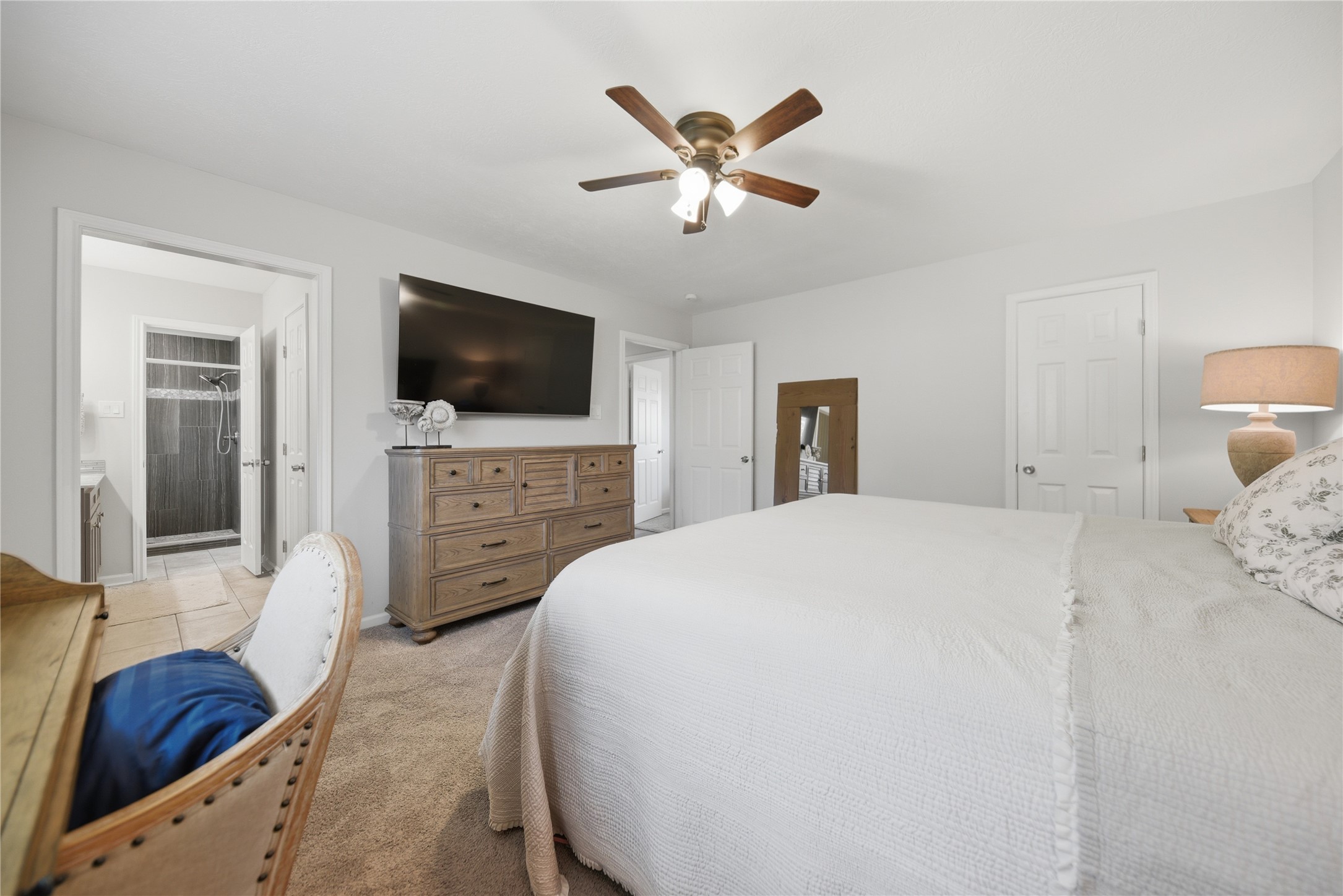 207 Briar Ridge Drive Bellville, TX 77418 - Photo 18 of 36 a spacious bedroom with a bed and a flat screen tv