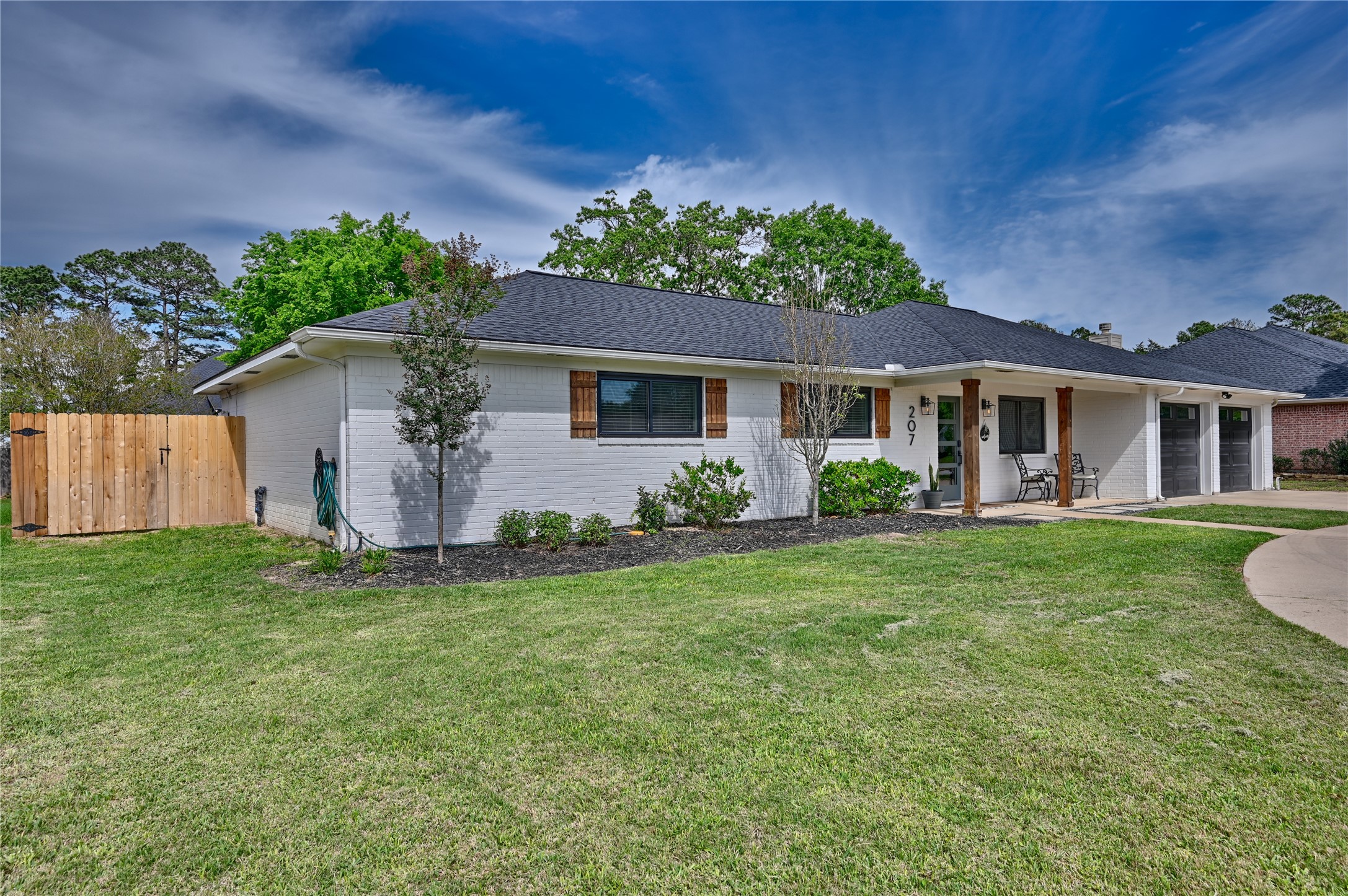 207 Briar Ridge Drive Bellville, TX 77418 - Photo 2 of 36 a backyard of a house with seating space