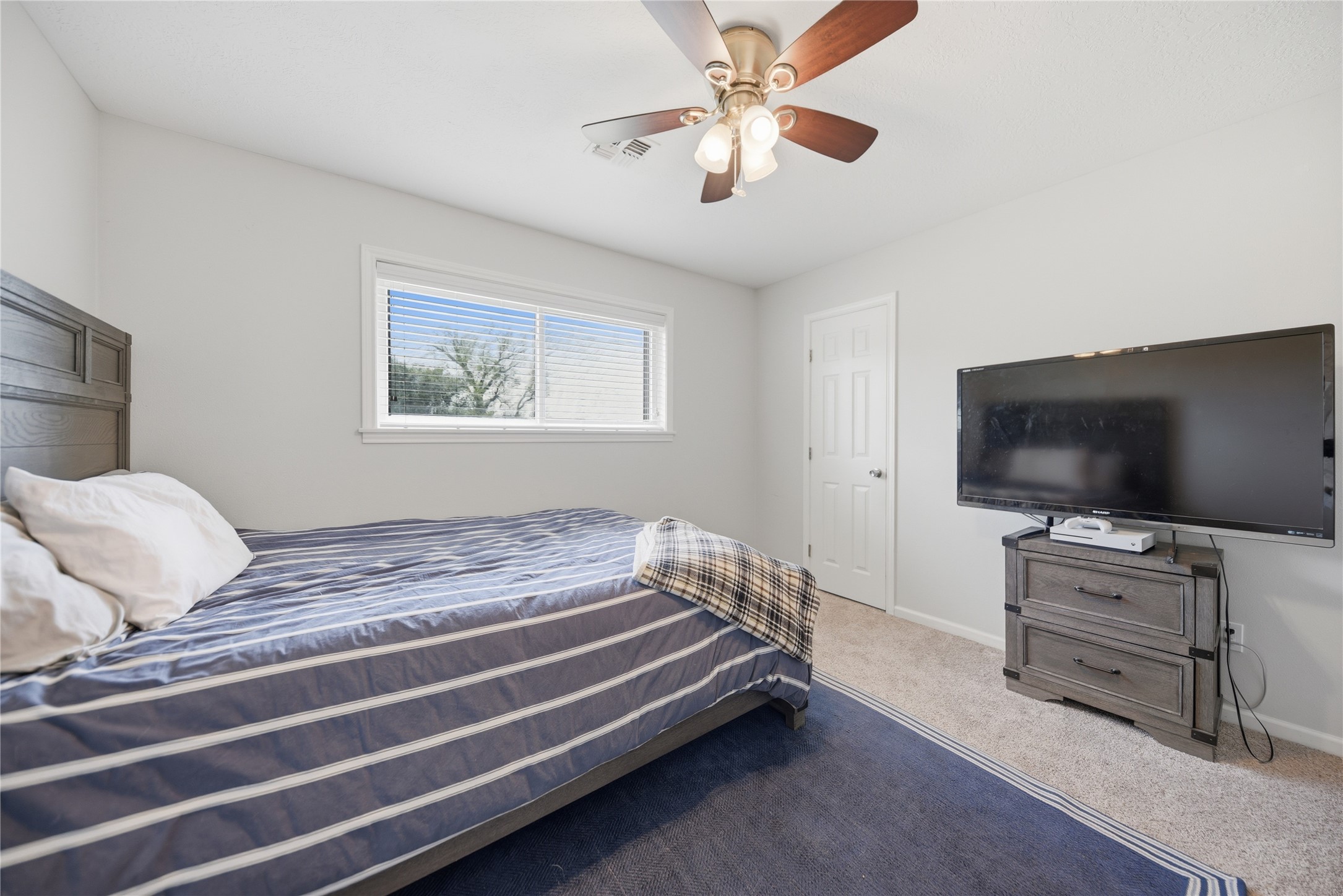 207 Briar Ridge Drive Bellville, TX 77418 - Photo 22 of 36 a bedroom with furniture and flat screen tv
