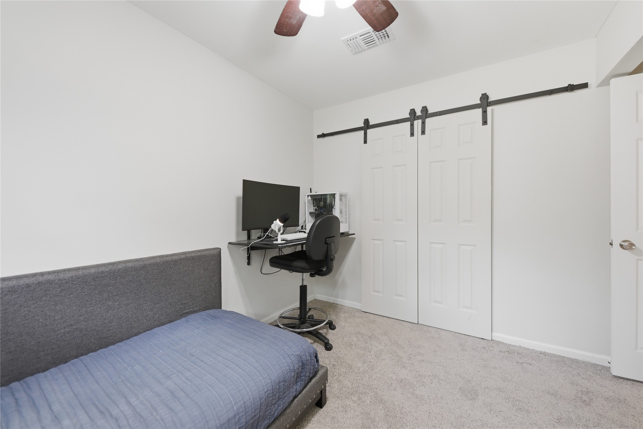207 Briar Ridge Drive Bellville, TX 77418 - Photo 28 of 36 a bedroom with a bed and a chandelier