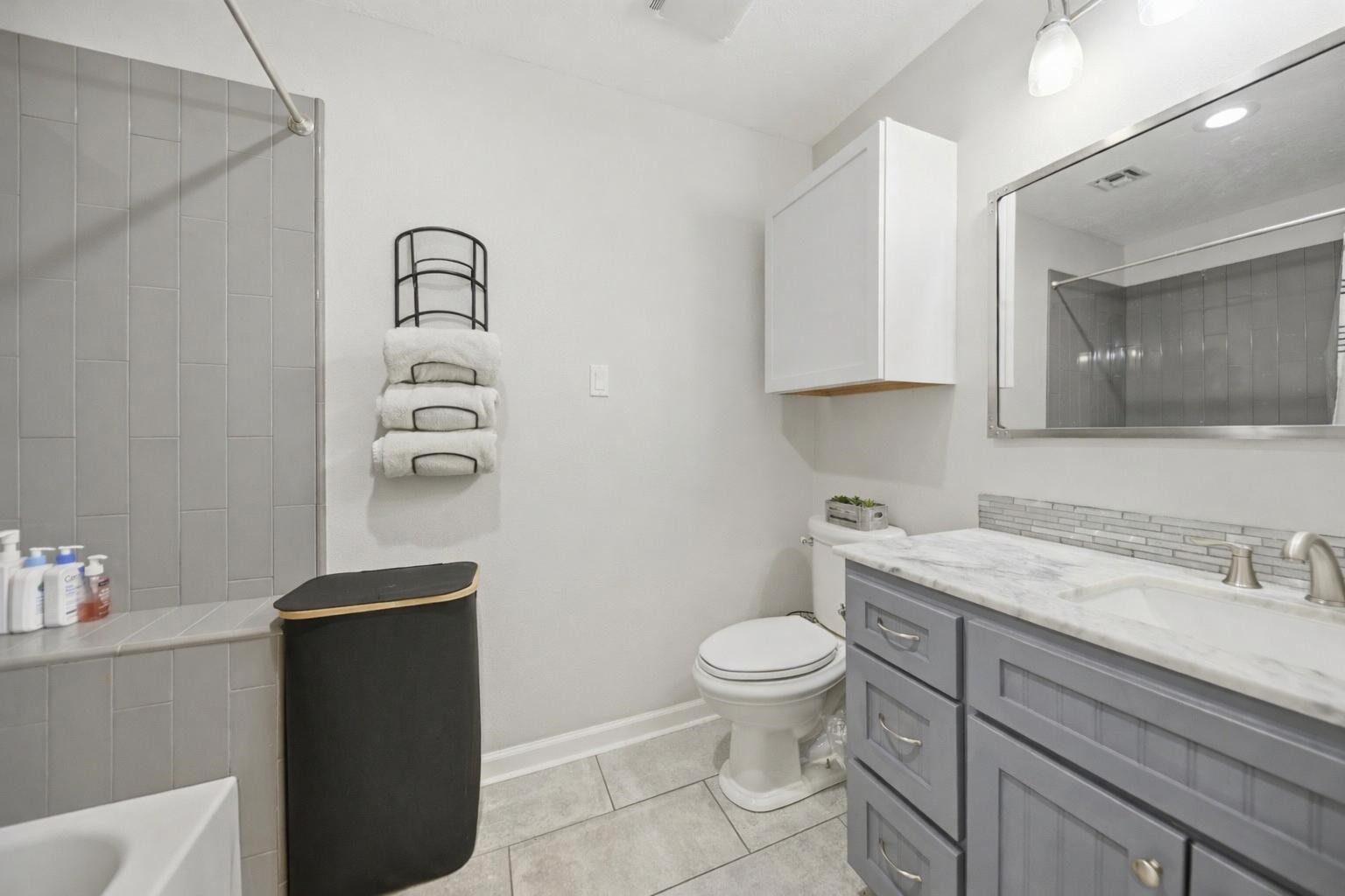 207 Briar Ridge Drive Bellville, TX 77418 - Photo 30 of 36 a bathroom with a granite countertop toilet sink and mirror