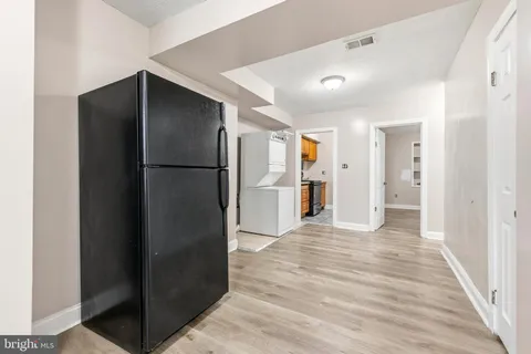 a view of a kitchen with a refrigerator and a microwave
