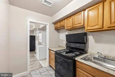 a kitchen with granite countertop a stove and a sink