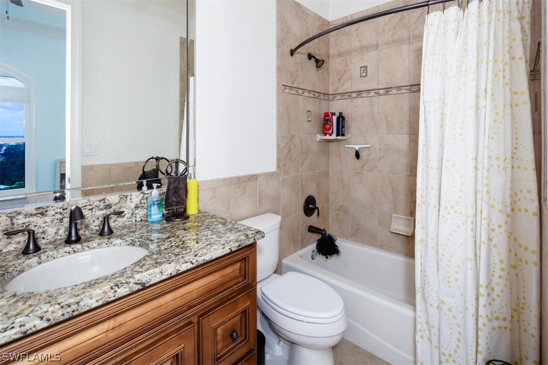 2797 First Street, Unit 2101 Fort Myers, FL 33916 - Photo 11 of 26 a bathroom with a granite countertop sink toilet and shower