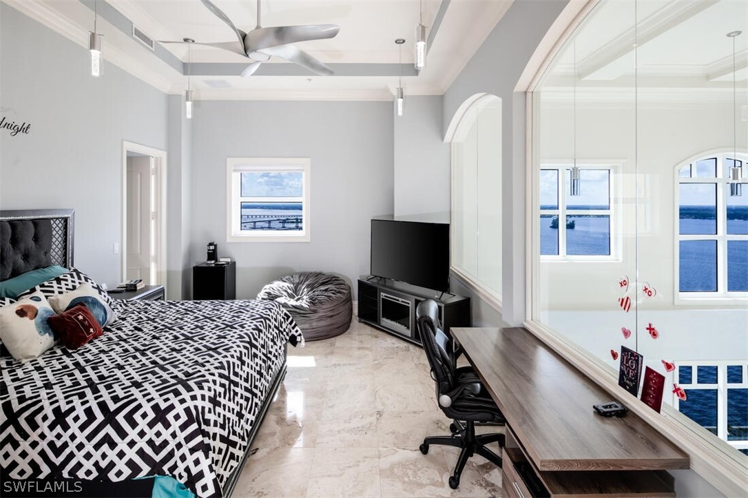 2797 First Street, Unit 2101 Fort Myers, FL 33916 - Photo 12 of 26 a bedroom with bed and a tv