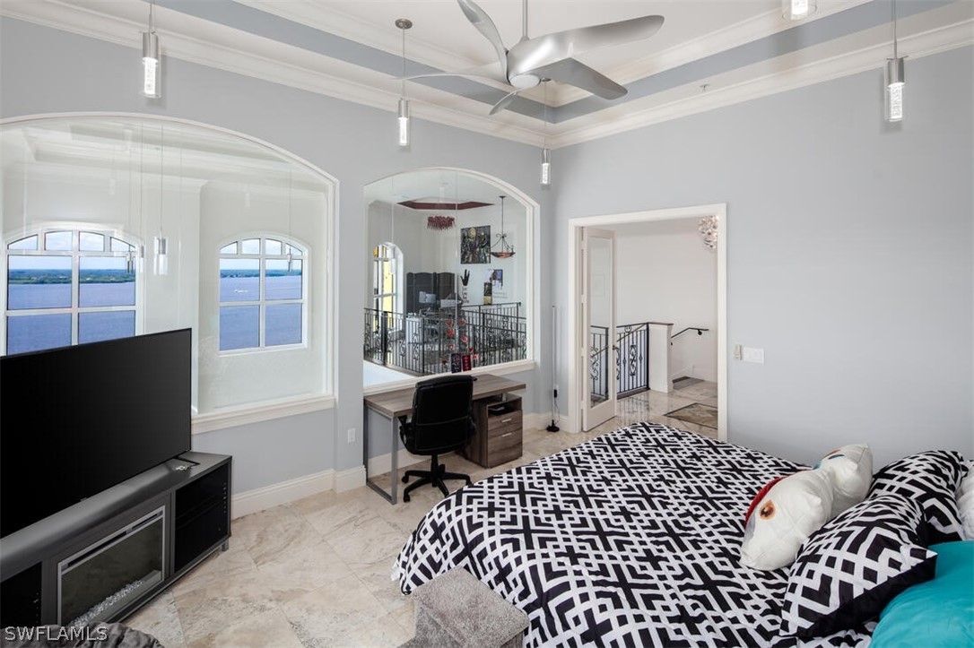 2797 First Street, Unit 2101 Fort Myers, FL 33916 - Photo 13 of 26 a bedroom with a bed and a flat screen tv