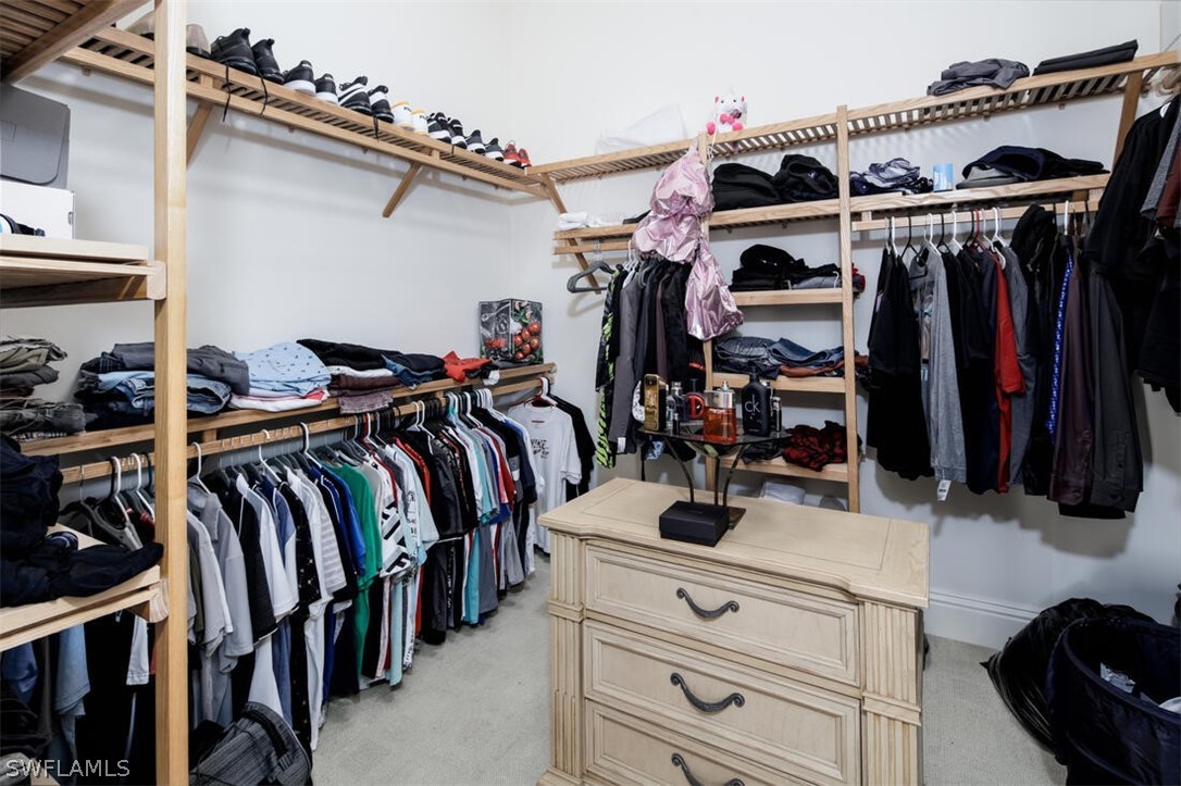 2797 First Street, Unit 2101 Fort Myers, FL 33916 - Photo 15 of 26 a view of walk in closet with clothes and shoes