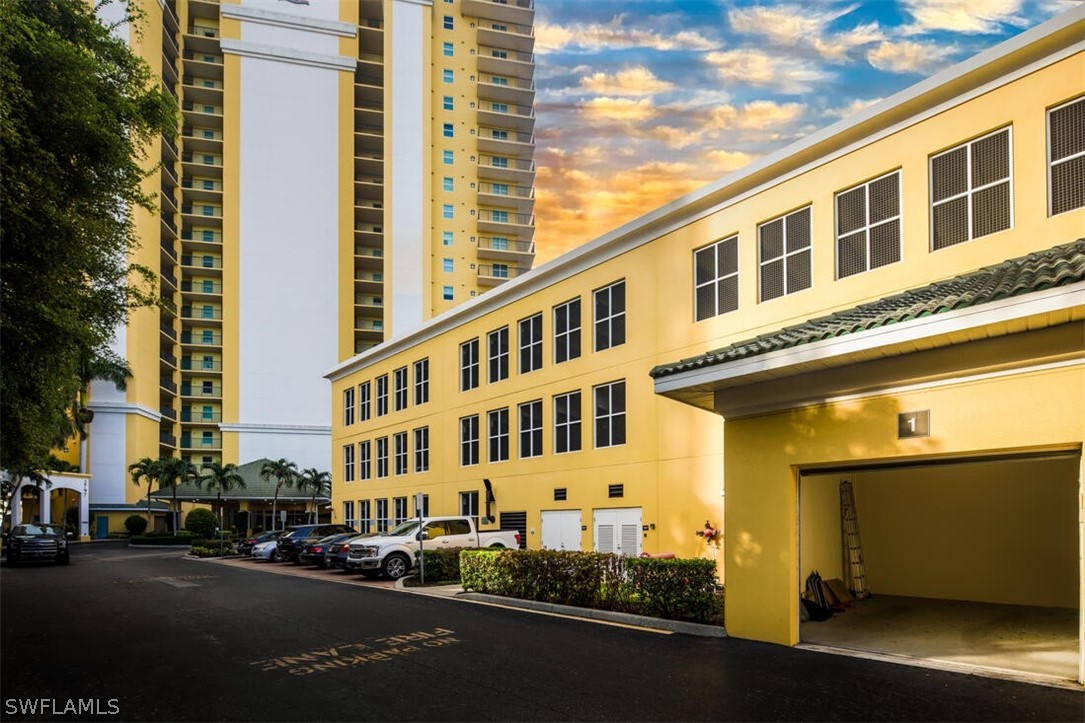 2797 First Street, Unit 2101 Fort Myers, FL 33916 - Photo 26 of 26 a city street lined with buildings and cars parked on the roadside
