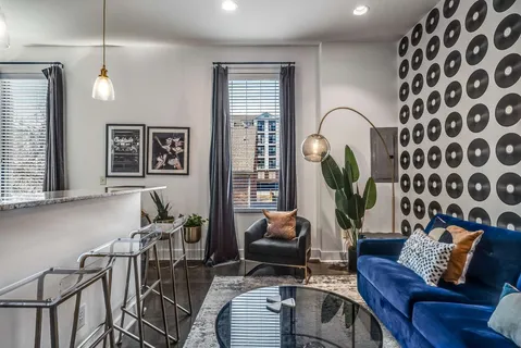 a living room with furniture lamp and rug