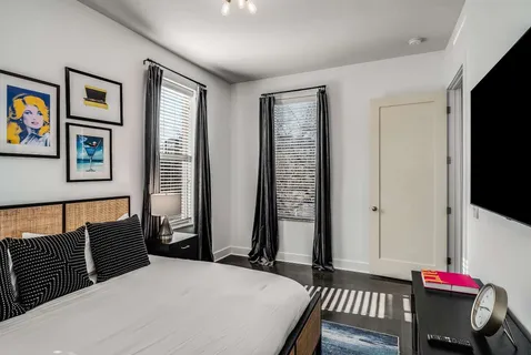 a bedroom with a bed and a flat screen tv