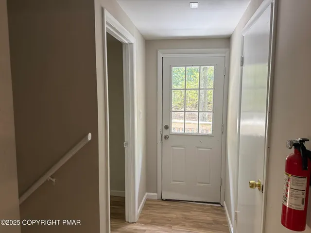 a view of hallway with wooden floor