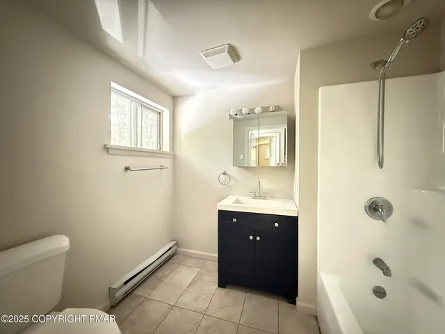 a view of a small space with wooden floor and a window