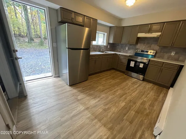 a kitchen with a stove and a sink