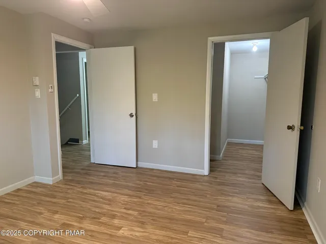 a view of an empty room and wooden floor