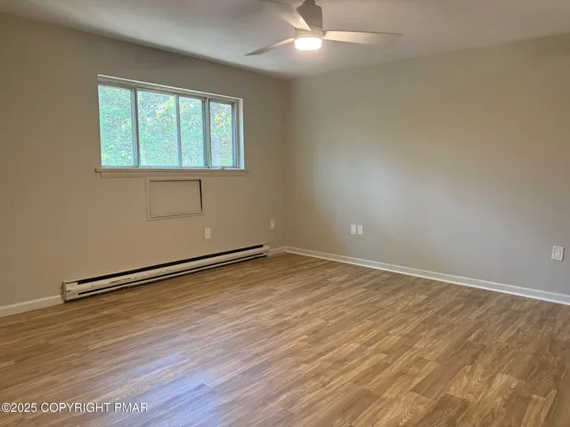 wooden floor in an empty room with a window