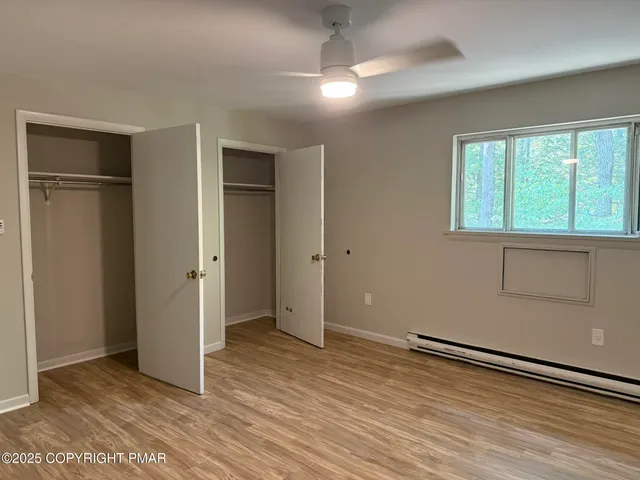 a view of an empty room and wooden floor