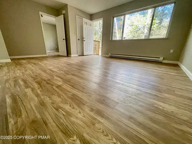 a bathroom with a bathtub shower sink and mirror