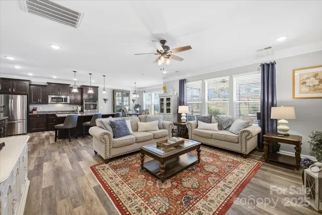 a living room with furniture ceiling fan and a rug