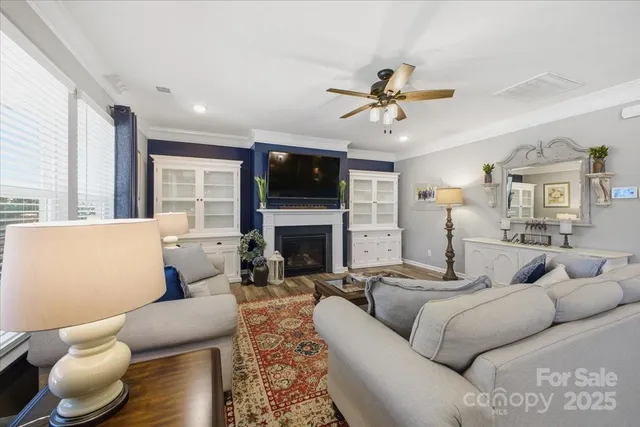 a kitchen with stainless steel appliances kitchen island granite countertop a dining table chairs and a refrigerator