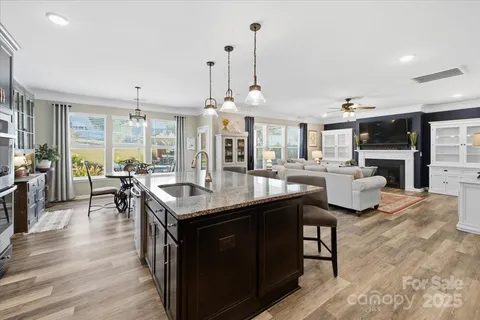 a kitchen with stainless steel appliances granite countertop a sink a stove and a refrigerator